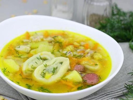 Гороховий суп на свинячих реберцях з часниковими рулетиками та копченими ковбасками